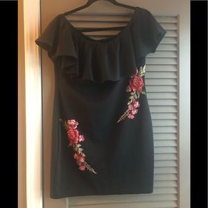 Black cocktail dress with floral appliqués